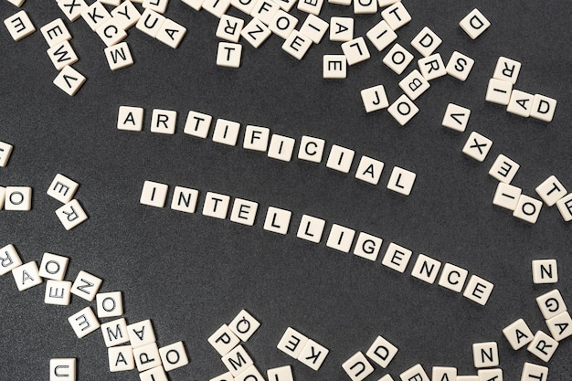 Photo words artificial intelligence spelled with tiles letters surrounded by chaotic letters of latin letters tech concept