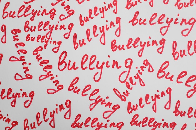 Words Bullying written on white background top view