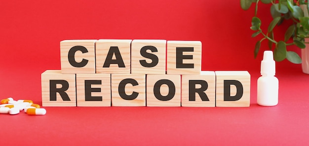 The words CASE RECORD is made of wooden cubes