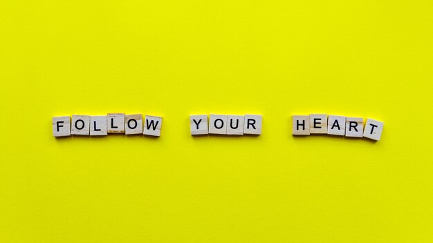 Words "Follow your heart" on a yellow paper.