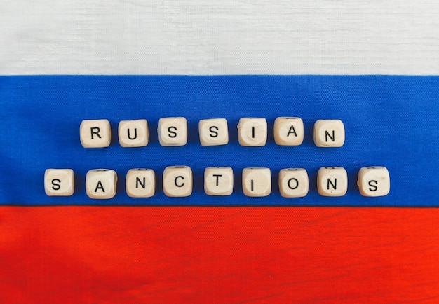 Photo the words sanctions against russia are written from wooden cube letters