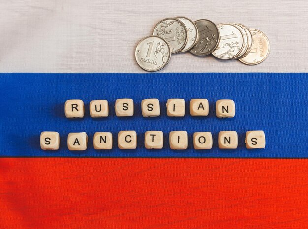 The words sanctions against Russia are written from wooden cube letters