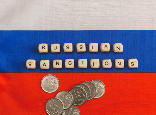 The words sanctions against Russia are written from wooden cube letters