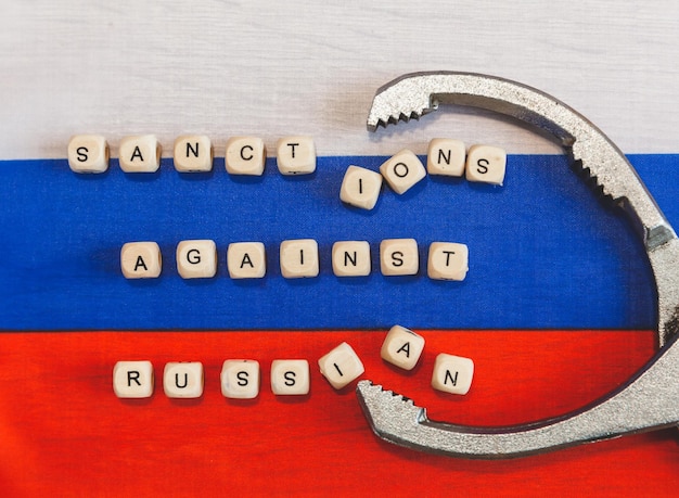 The words sanctions against Russia are written from wooden cube letters