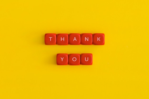 The words Thank you on a red cubes