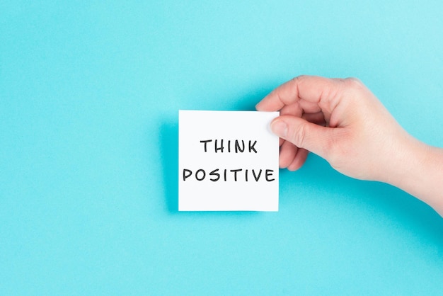 The words think positive are standing on a paper, optimistic mindset, coaching and motivation