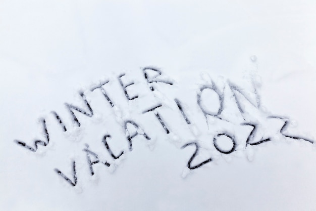 Photo words winter holidays drawn on snow