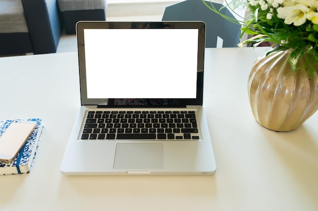 Work desk with modern laptop, copy space on blank screen