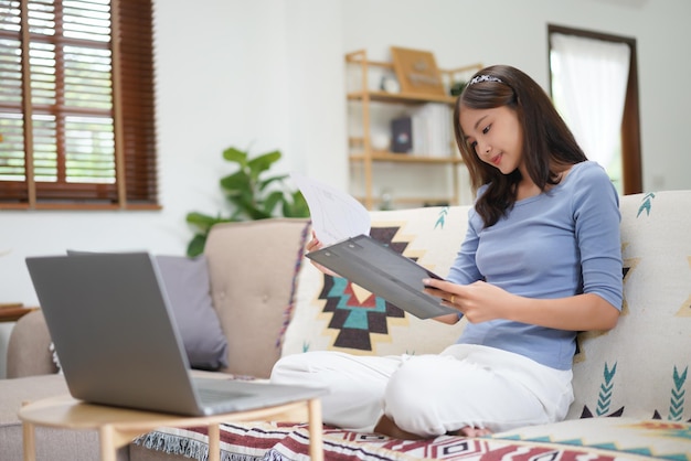 Concetto di lavoro da casa donne d'affari che leggono i dati finanziari del grafico mentre lavorano in remoto a casa