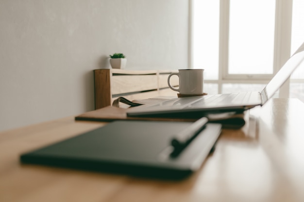 Work from home creative items set of a laptop and pen tablet in the apartment.