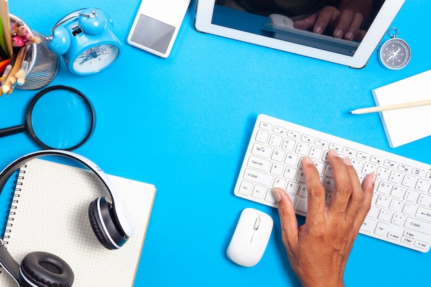 Photo work at home concept of business objects on blue background.