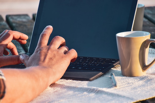 work at home, man works on laptop in the backyard