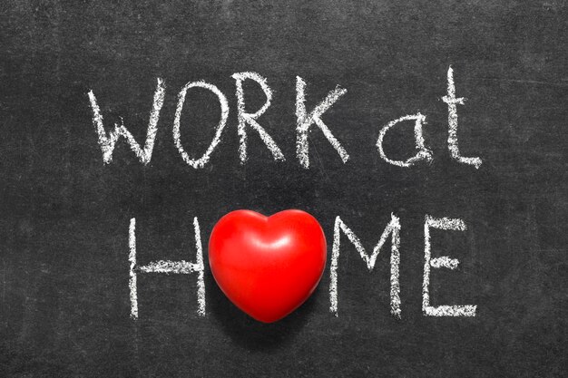 Work at home phrase handwritten on blackboard with heart symbol instead of O