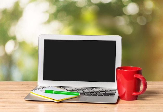 Work office desk with a cup of coffee and computer laptop