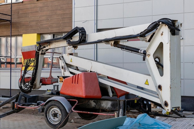 The work of people is at a height. Facade decoration of the building. Self-propelled construction mechanism for lifting workers to a height on a construction site. Safe work at the top.