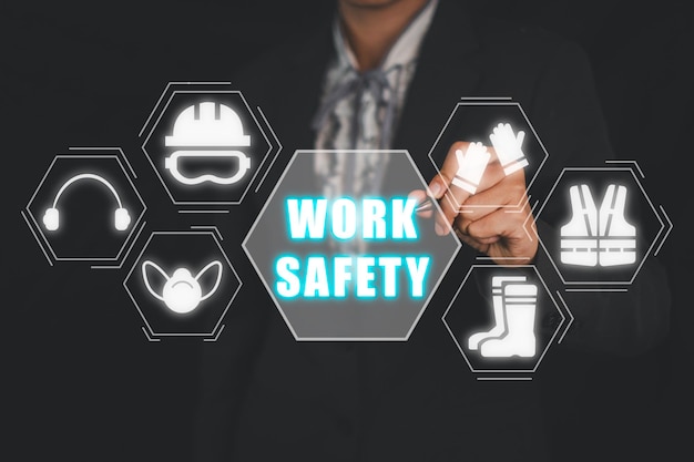 Work safety concept Businesswoman hand touching work safety icon on virtual screen