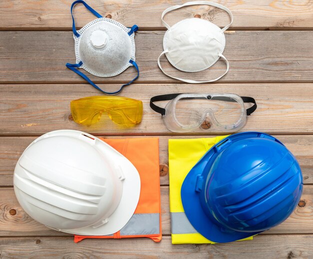 Work safety protection equipment on wooden background