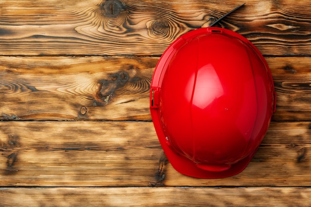 Work safety protection hardhat on wooden top view