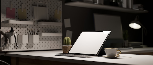 work space at night tablet empty screen on white table decor with stationery office in evening