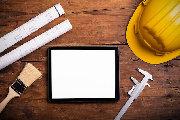 Work tools with tablet on wooden background close up