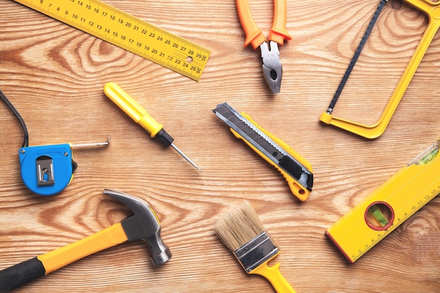 Work tools on wooden background.