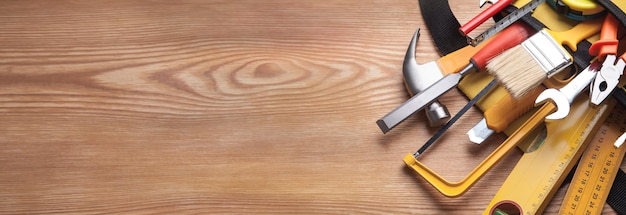 Work tools on wooden background