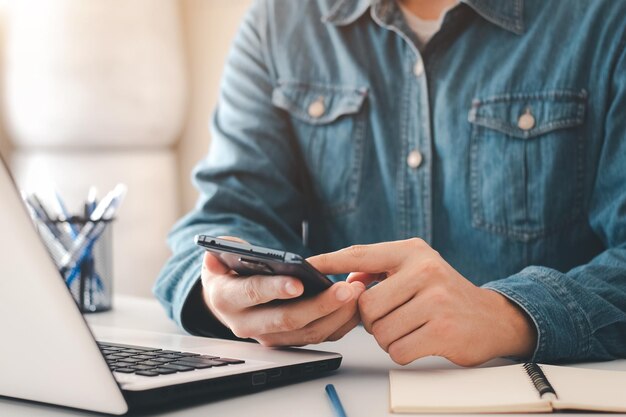 work using mobile phone typing computer mobile chat laptop contact us at workplaces planning ideas investors internet searching ideas connecting people
