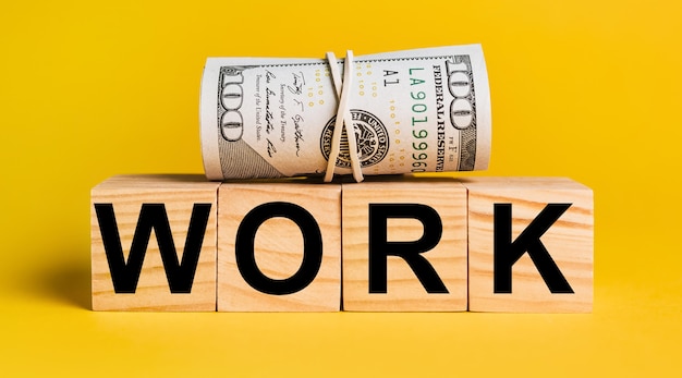 WORK with money on a yellow background.