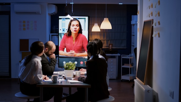 Workaholics multiethnic businesspeople discussing financial strategy during online videocall meeting