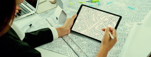 Photo worker architect and engineer work on real estate construction project oratory planning with cartography and cadastral map of urban town area to guide to construction developer business plan of city