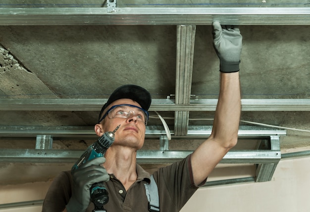 Worker assembles profile metal frame