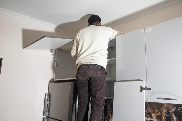 Worker assembling of new kitchen furniture