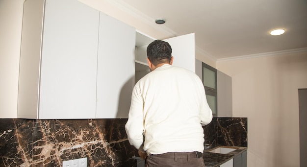 Worker assembling of new kitchen furniture