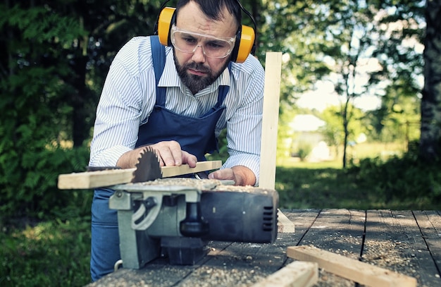 Worker beard man with circular saw