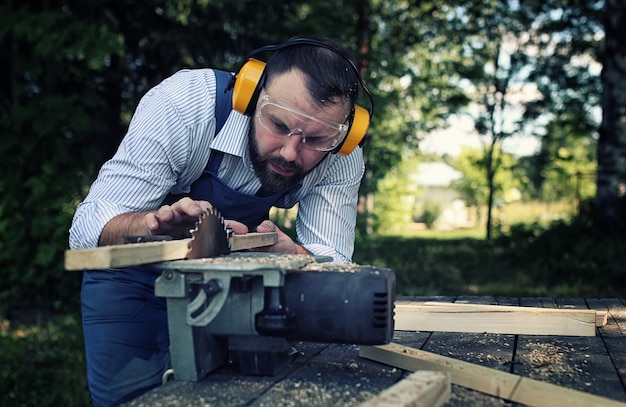 Worker beard man with circular saw