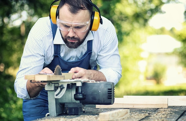 Worker beard man with circular saw