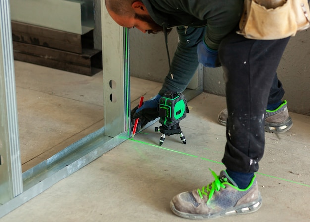 Worker builds a plasterboard wall