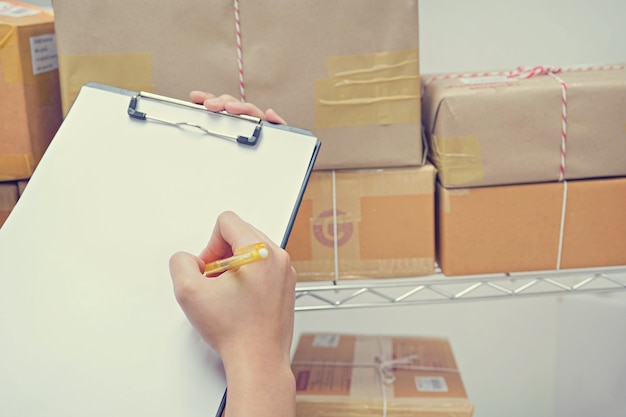 Worker checking Package In Warehouse