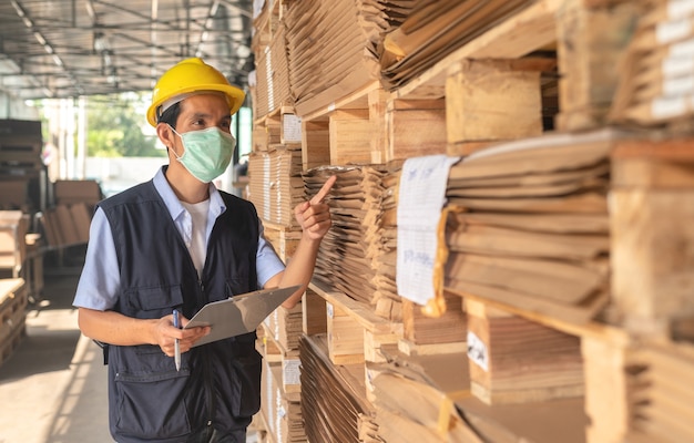 Worker checking raw material inventory in  factory