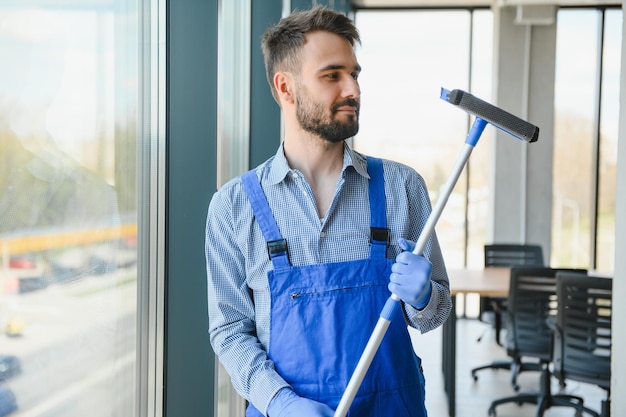 Worker cleaning windows service on high rise building