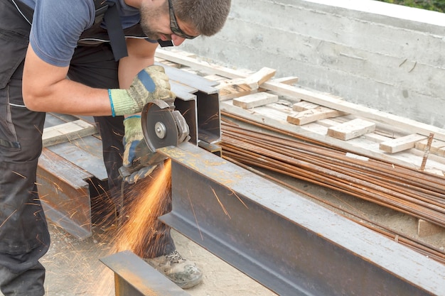 Worker cuts metal product with electric flex