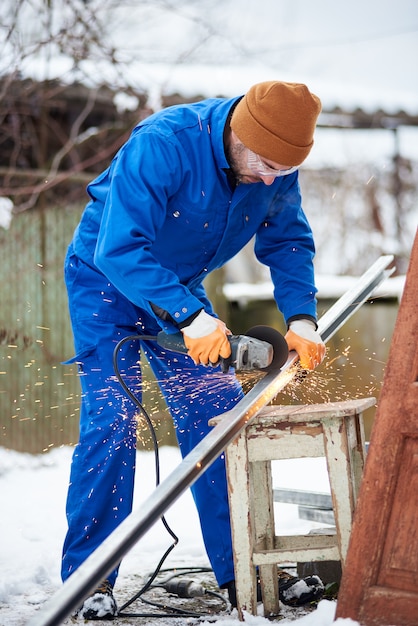 Worker cuts the panel frame