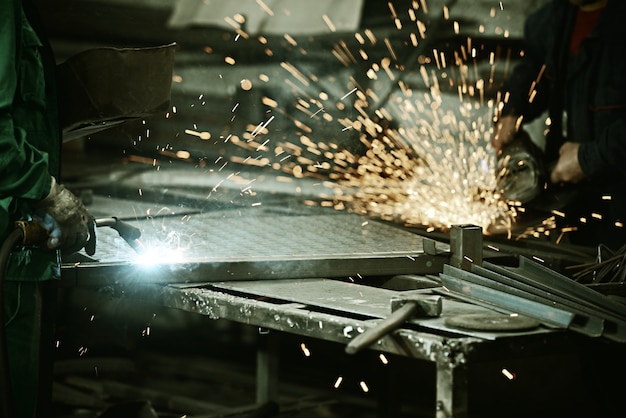 Worker cutting iron with professional tool