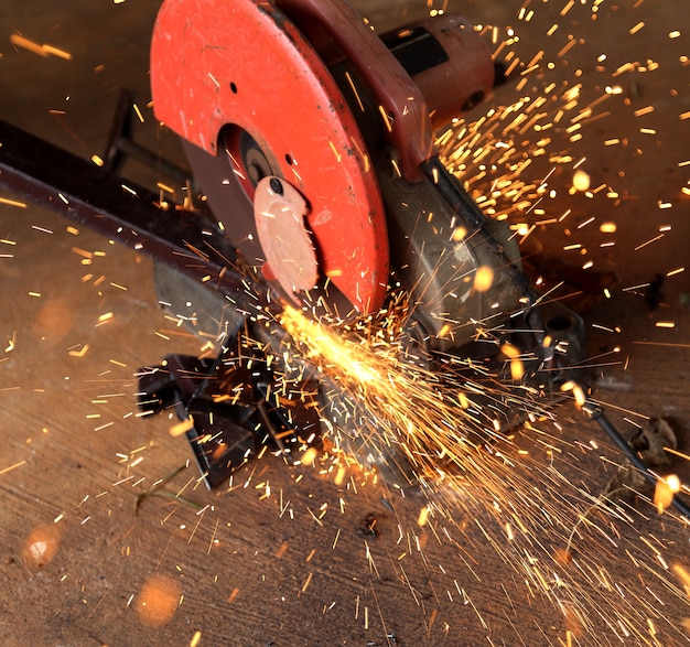 Worker cutting metal and spark