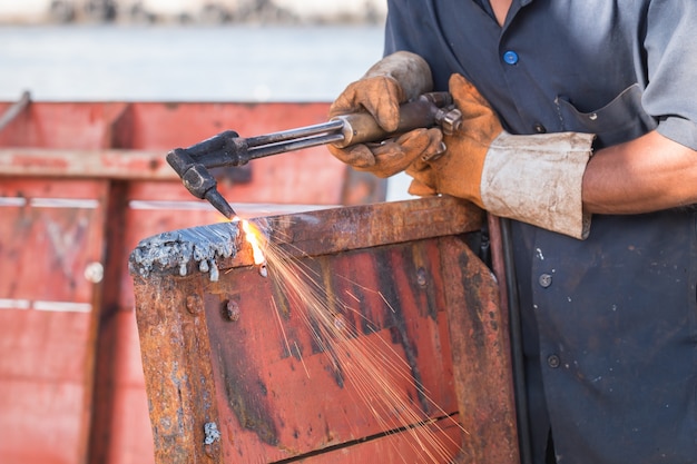 A worker cutting steel using metal torch