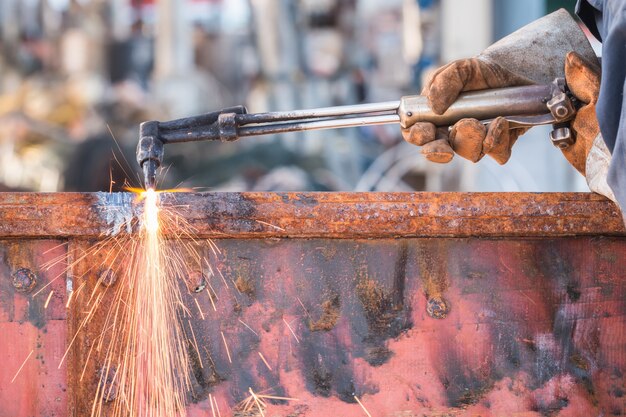 A worker cutting steel using metal torch