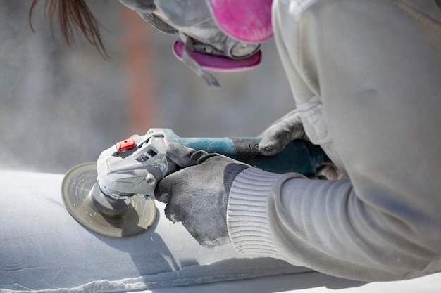 Worker cutting stone with grinder