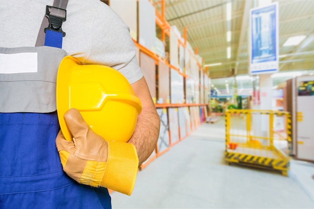 Worker and dark texture in background. Concept of OSH (occupational safety and health)