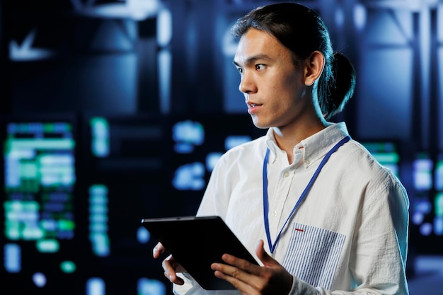 Worker in data center with tablet