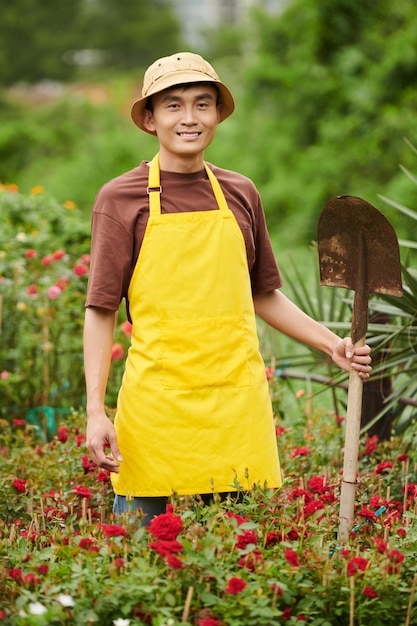 Worker Digging out Blooming Flowers